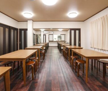 Long communal dining room with wooden tables and stools at Onsenminshuku Kosakaya, Wakayama, Kansai Japan