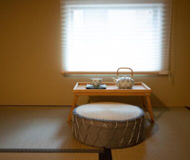 Tatami room with low tea table, kettle and round cushion at Onya Kaede, Kyoto