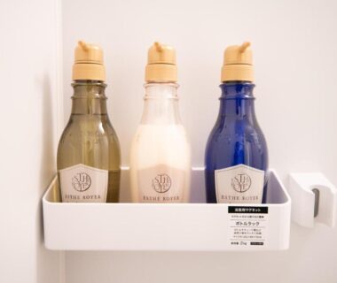 three wall-mounted bath dispensers on white shelf in ryokan bathroom at Onya Kaede Kyoto
