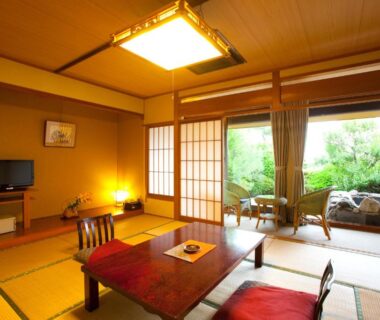 Traditional tatami room with low table, shoji screens and garden view at Onyado Satsuki in Kumamoto, Kyūshū