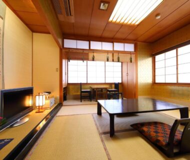 Traditional tatami room with low table, zabuton cushions, shoji screens and tokonoma at Onyado Takasago, Saga