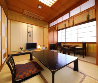 Tatami room with low lacquer table, zaisu chairs, shoji screens and alcove at Onyado Takasago, Saga
