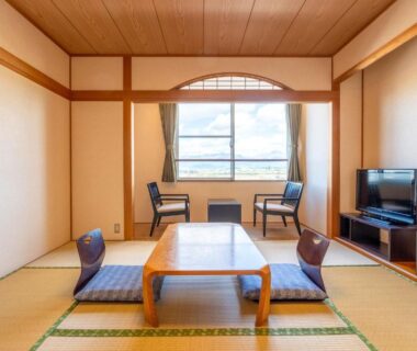 Traditional tatami room with low table, floor chairs and window seating at Ooedo Onsen Monogatari Aizu, Fukushima