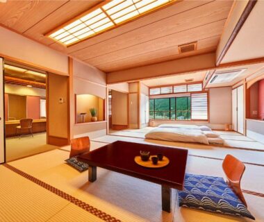 Tatami room with futon bedding, low table and shoji screens at Ooedo Onsen Monogatari Gero Bekkan, Gifu