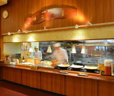 Chefs preparing buffet behind counter at Ooedo Onsen Monogatari Hotel Shinko, Yamanashi