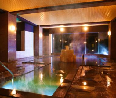 Warm indoor onsen pools with stone floor and wooden soaking tub at Ooedo Onsen Monogatari Kounkaku Miyagi Tōhoku