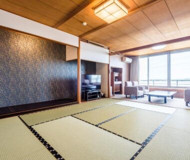Tatami room with low table and seating at Ooedo Onsen Monogatari Nagayama in Ishikawa