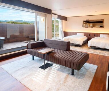 Twin beds, lounge seating and balcony wooden soaking tub at Ooedo Onsen Monogatari Premium Enakyo, Gifu