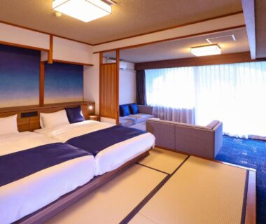 Tatami room with twin beds, sofa seating and large window at Ooedo Onsen Monogatari, Kinugawa, Tochigi