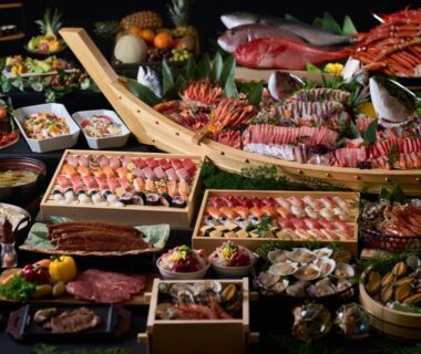 Extensive spread of fresh seafood, sushi, shellfish and assorted Japanese dishes on low tables for communal ryokan dining