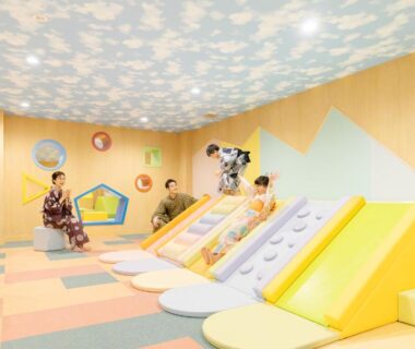 Colorful indoor playroom with soft slides, padded mats and kimono-clad guests at Ooedo Onsen Monogatari Premium Yamanaka Grand Hotel Ishikawa