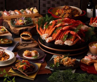 Assorted crab and seafood dishes arranged on platters at Ooedo Onsen Monogatari Premium Yamashitaya, Ishikawa