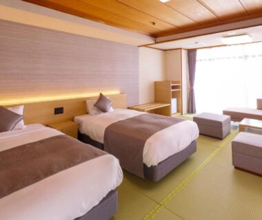Tatami room with twin beds and low table at Ooedo Onsen Monogatari Premium Yamashitaya in Ishikawa Chūbu