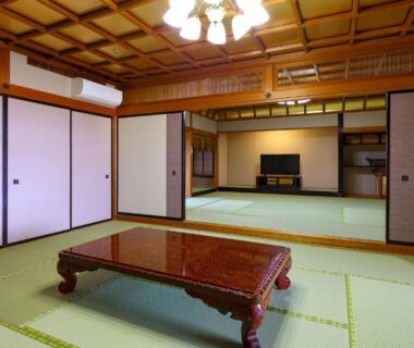 Tatami-floored room with low table and sliding doors at Ooedo Onsen Monogatari Premium Yamashitaya, Ishikawa Japan