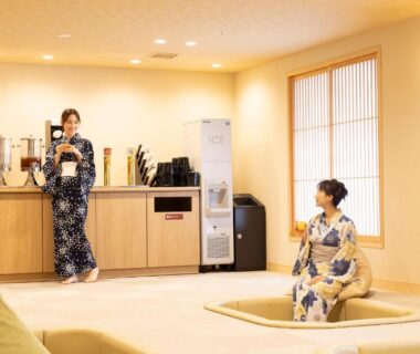 Two guests in yukata seated in ryokan lounge at Ooedo Onsen Monogatari Premium Yoshinoya Irokuen, Ishikawa