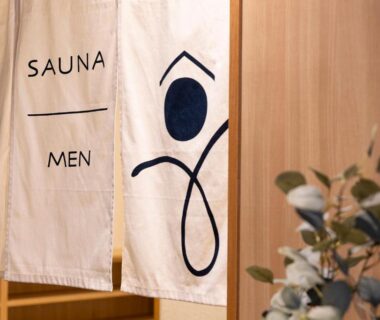 White noren reading SAUNA MEN above wooden doorway with plant at Ooedo Onsen Monogatari Premium Yoshinoya Irokuen, Ishikawa