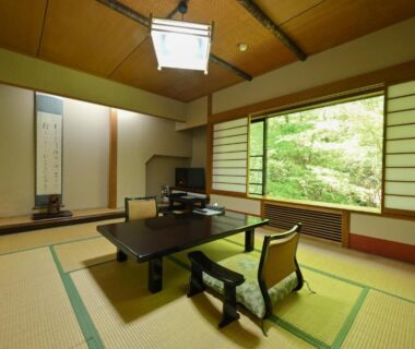 Tatami room with low table and shoji screens at Osakaya Ryokan in Gunma