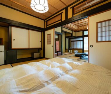Traditional tatami room with futon bedding, shoji screens and wooden accents at Osawayama Onsen Osawakan in Niigata