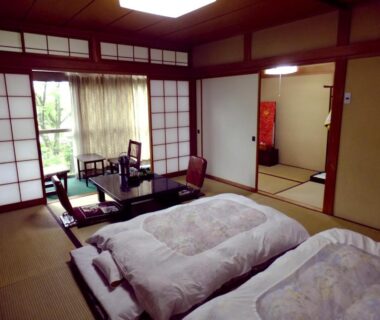 Tatami room with futons, shoji screens and low table at Oshi Ryokan, Nagano, Chūbu