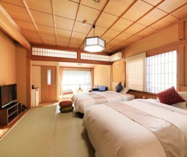 Tatami room with twin beds, shoji screens and wooden ceiling at Otogitei Kofu, Nagano