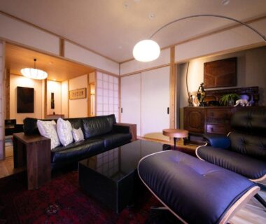 Lounge with leather chair, sofa, shoji screens and tatami room visible at Oyado Den Rikyu, Ōita