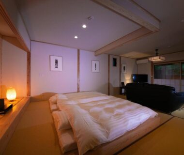 Tatami room with futon beds and shoji screens at Oyado Den Rikyu in Ōita, Kyūshū