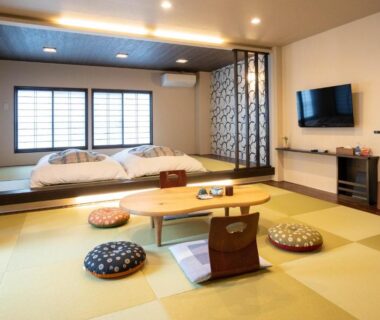 Traditional tatami room with futons, low table and zabuton cushions at Oyado Eitaro in Gifu