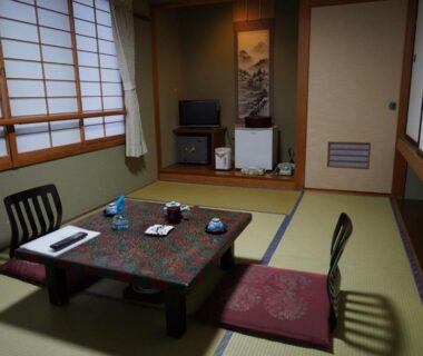 Traditional tatami room with low table, zabuton cushions and shoji screens at Oyado Eitaro in Gifu, Chūbu Japan