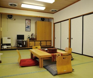 Traditional tatami room with low wooden table, cushions, shoji window and sliding fusuma doors at a Tochigi ryokan