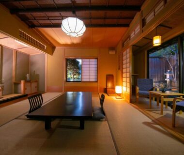 Traditional tatami room with low lacquer table, shoji screens and garden view at Oyado Ichizen in Oita Kyushu