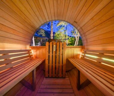 Interior of wooden barrel sauna with circular window at Oyado Ichizen in Ōita, Kyūshū
