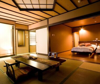 Tatami room with low table and beds at Oyado Kinkiyu Annex SUIKAZURA Hokkaidō Japan