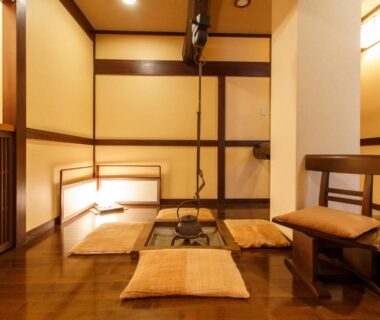 Low seating with cushions, wooden floor and kettle hearth at Oyado Koto No Yume, Gifu, Chūbu