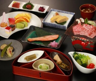 Assorted Japanese dishes on lacquer trays with grilled fish, sliced beef, pickles and fruit at Oyado Koto No Yume, Gifu