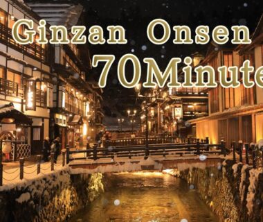 Lit wooden ryokan buildings along a river at Ginzan Onsen near Oyado Morinone in Yamagata
