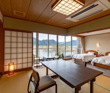 Tatami room with twin beds, low table, shoji screens and mountain view at Oyado Seri, Hyōgo
