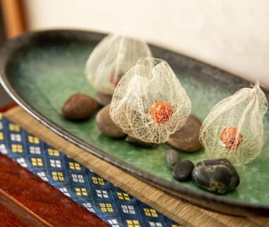 Gauze-wrapped lantern fruits and decorative stones on ceramic tray at Oyado Seri, Hyōgo, Kansai