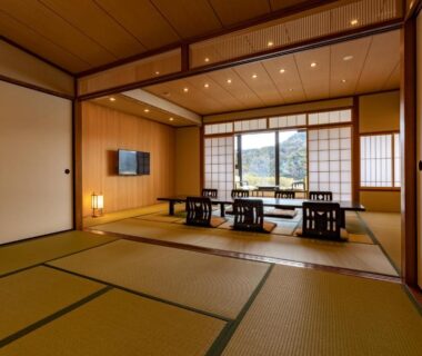 Spacious tatami room with low dining table, shoji screens and garden view at Oyado Seri in Hyōgo, Kansai