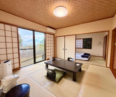 Traditional tatami room with low table, zabuton cushions and sliding shoji at Oyado Tamayura in Oita, Kyushu