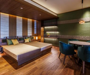 Modern tatami-style room with low platform bed, shoji screens and dining table at Oyado The Earth in Mie, Kansai