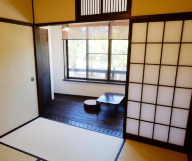 Traditional tatami room with shoji screens, low table and cushions at Oyado Tsukiusagi in Hiroshima, Chūgoku