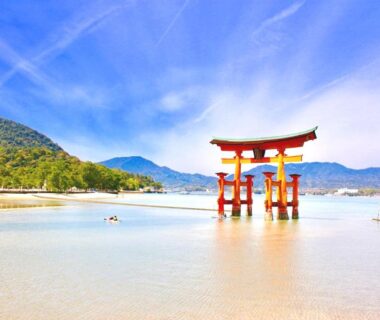 Red torii gate in shallow tide, near Oyado Tsukiusagi, Hiroshima, Chūgoku, Japan