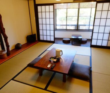 Tatami room with low table, cushions and shoji screens at Oyado Tsukiusagi in Hiroshima, Chūgoku, Japan