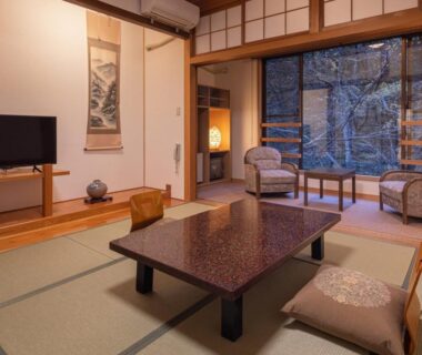 Tatami room with low table, shoji screens and garden view at Oyado Tsuruya Nagano