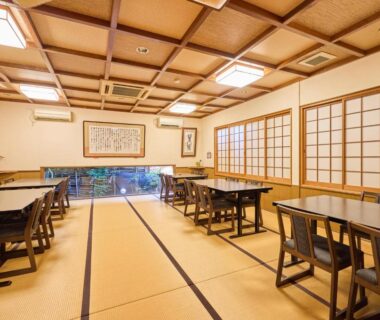 Tatami dining room at Oyado Yumechidori in Saga with shoji screens, wooden tables and garden view