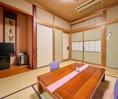 Traditional tatami room with low wooden table, zabuton cushions, shoji screens, and alcove at Oyado Yumechidori, Saga