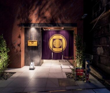 Evening noren entrance with stone walkway, lanterns and plants at PROSTYLE Ryokan Yokohama Bashamichi, Kanagawa
