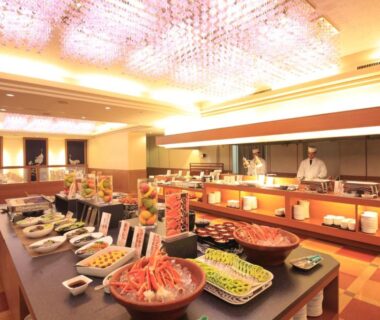 Buffet spread with assorted dishes and chefs in warm-lit dining room at Park Hotel Miyabitei Hokkaidō Japan