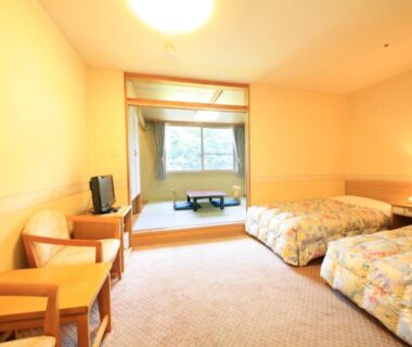 Western twin beds, raised tatami seating with low table and chairs, window overlooking greenery at Park Hotel Miyabitei Hokkaidō