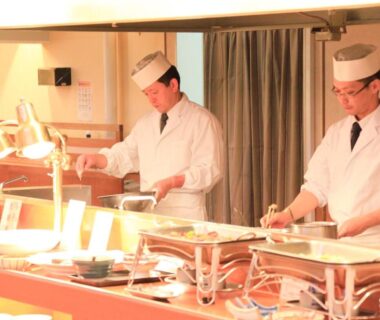 Two chefs preparing buffet dishes at Park Hotel Miyabitei dining area in Hokkaidō